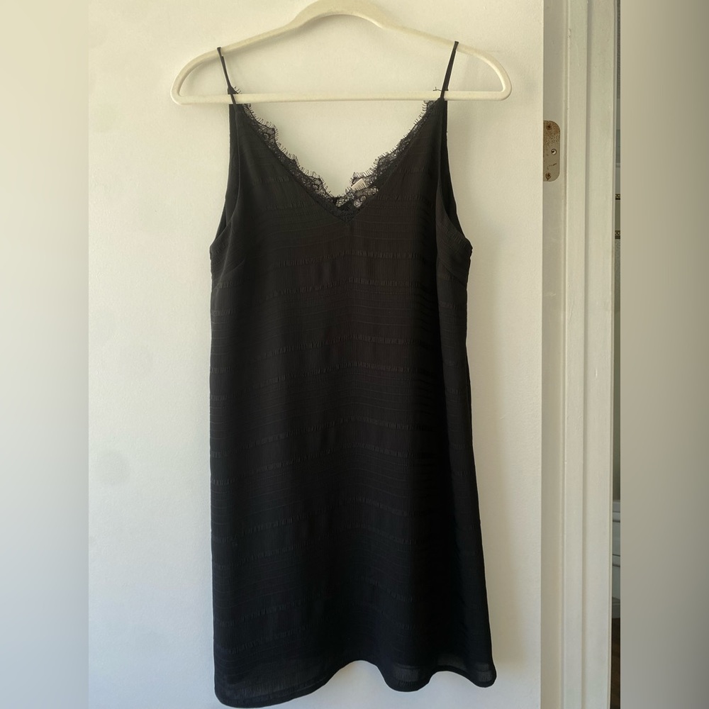Black mini slip dress. Laced neckline. Size XS